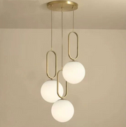 Lustra suspendata 3 globuri opalescente, suport cupru auriu, inel oval decorativ, soclu E27, montaj tavan interior