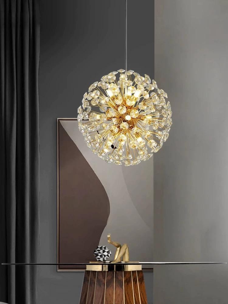 Candelabru glob cristal auriu D30cm, 6 surse G9, forma sferica tip papadie, suspendat deasupra unei mese elegante