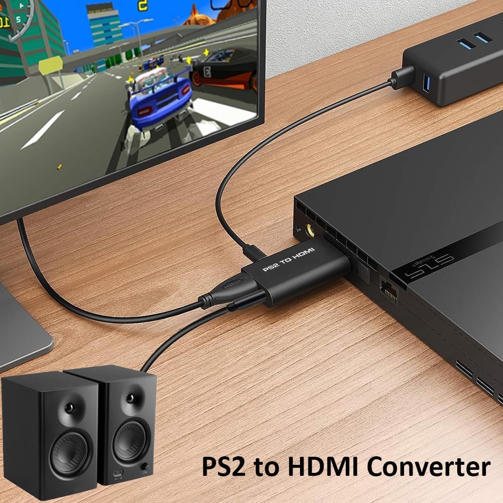 Convertor PS2 la HDMI utilizat pe birou, conectat la consola si monitor cu boxe stereo externe