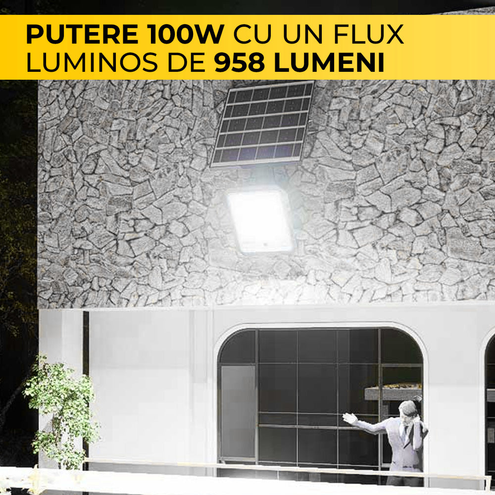 Proiector solar LED 100W, 958 lumeni, iluminand fatada unei cladiri pe timp de noapte