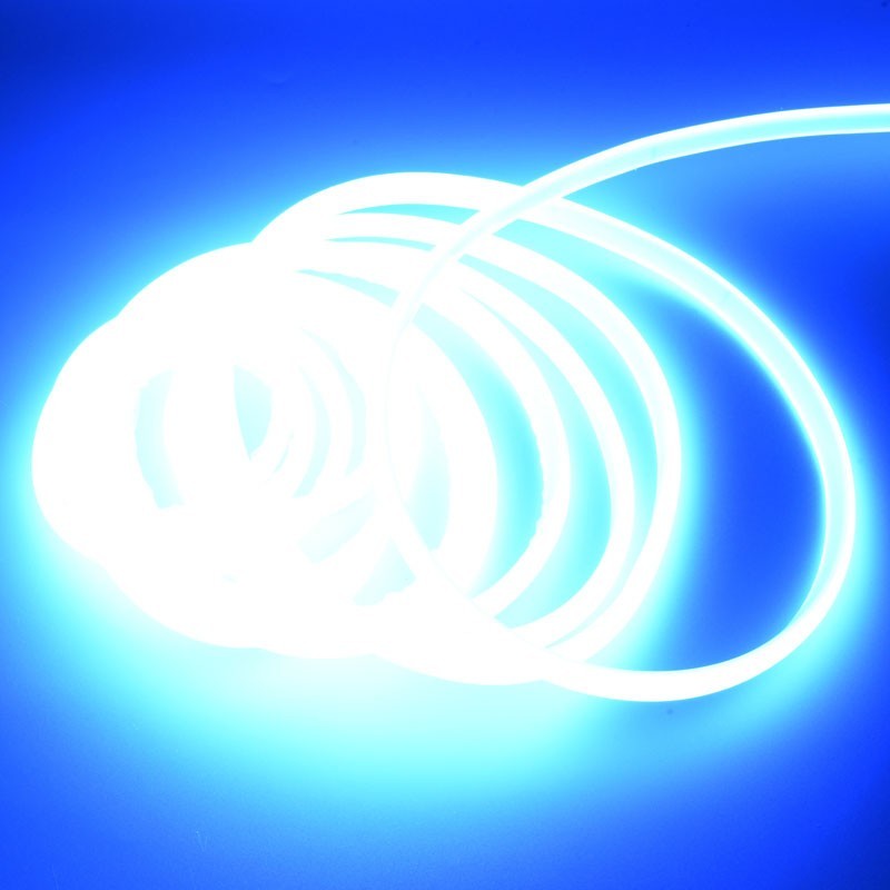Banda LED COB neon flex albastra desfasurata, flexibila, lumina albastra vie pe fundal intunecat